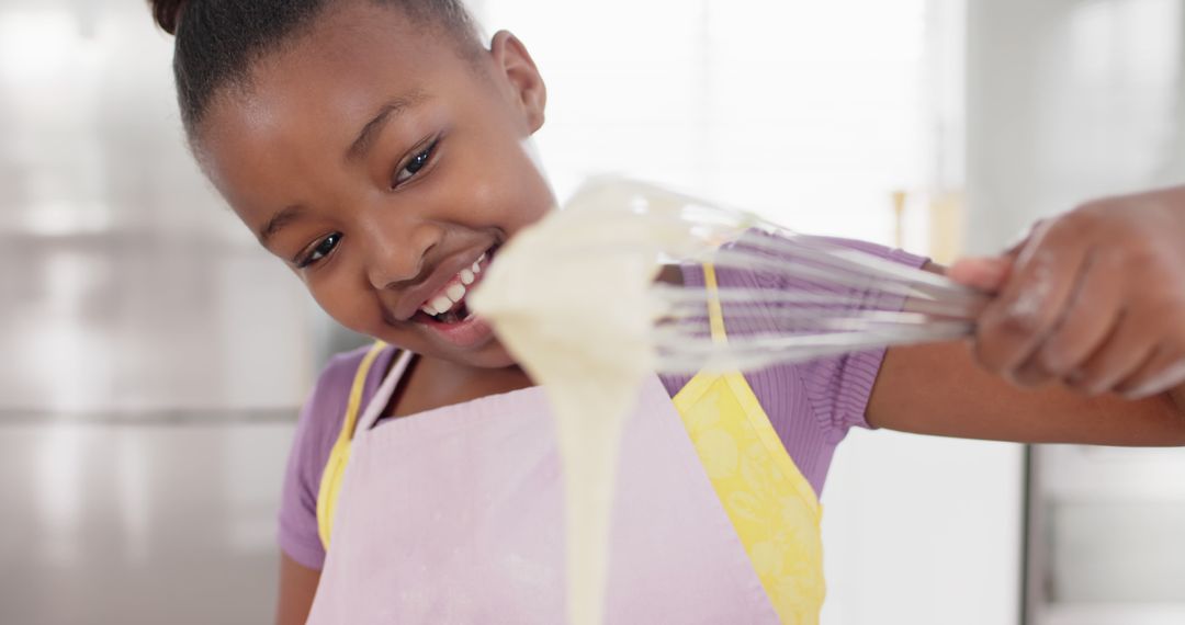 Young Girl Smiling While Baking in Kitchen - Free Images, Stock Photos and Pictures on Pikwizard.com