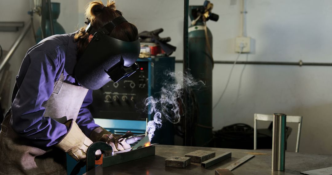 Female Welder Working with Metal in Industrial Workshop - Free Images, Stock Photos and Pictures on Pikwizard.com