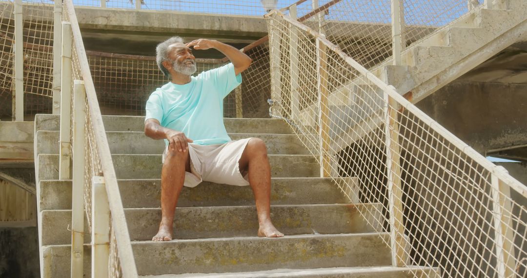 Active Senior Man Sitting on Stairway Looking Ahead Confidently