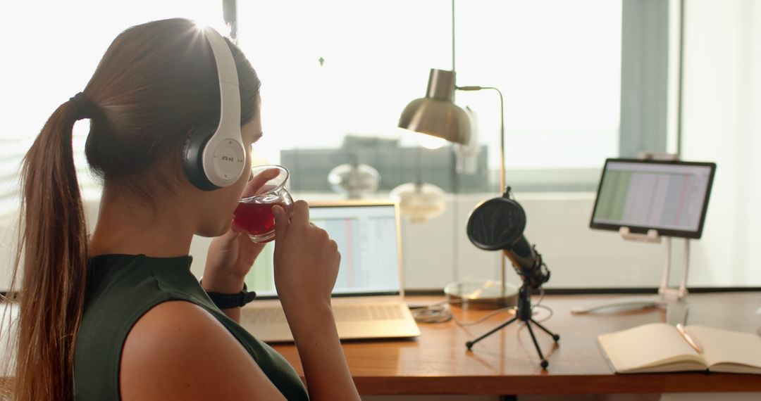 Woman Podcasting at Home Office with Laptop and Microphone Setup