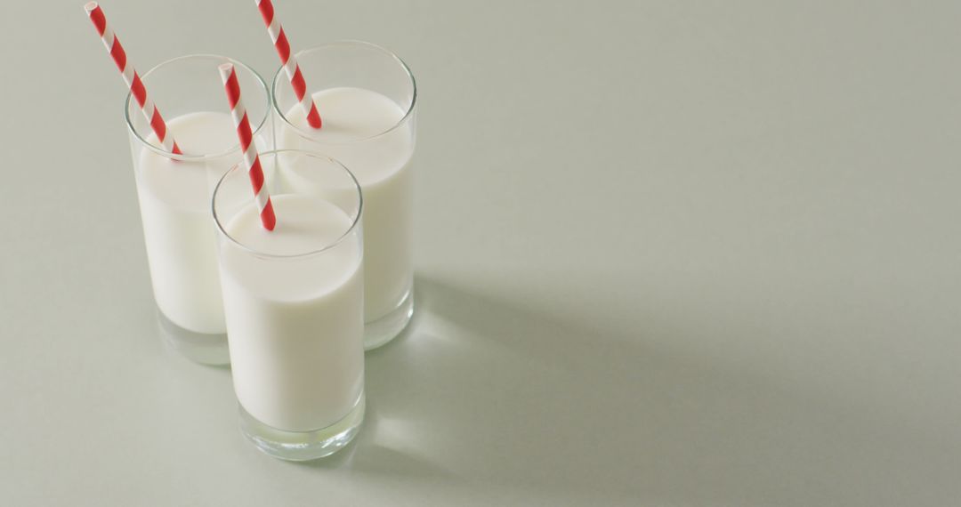 Fresh Glasses of Milk With Red Striped Straws on Light Surface - Free Images, Stock Photos and Pictures on Pikwizard.com