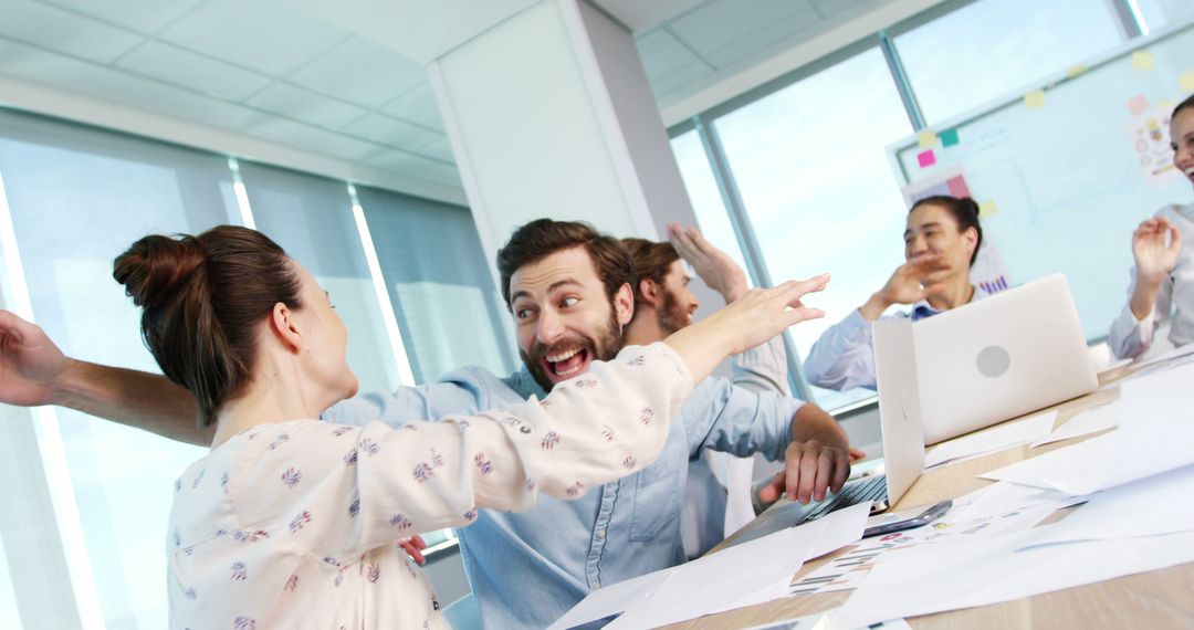 Coworkers Celebrating Success in Modern Office Environment - Free Images, Stock Photos and Pictures on Pikwizard.com