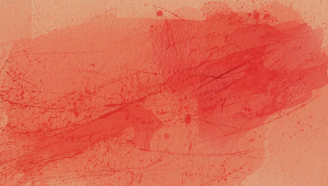 Abstract red watercolor wash spreading across textured paper with splatters and scratches