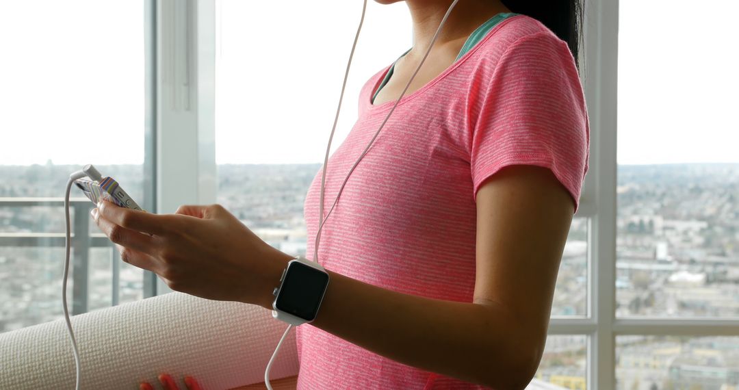 Woman Preparing for Yoga Workout at Home with Smartwatch - Free Images, Stock Photos and Pictures on Pikwizard.com