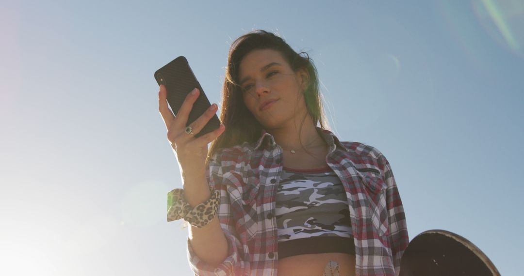 Teenage Girl Checking Her Smartphone During Sunset - Free Images, Stock Photos and Pictures on Pikwizard.com