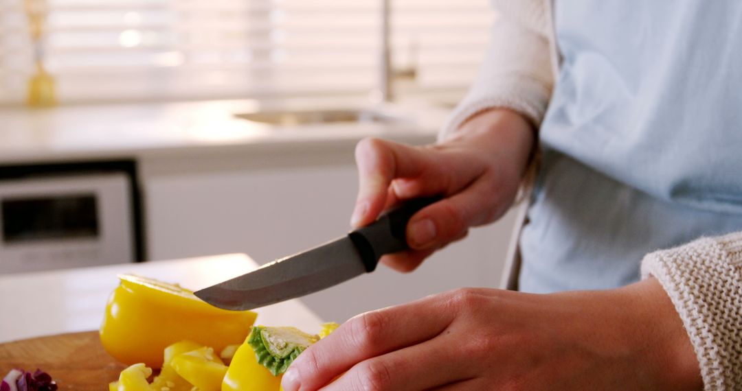 Closeup of Person Chopping Yellow Bell Pepper in Modern Kitchen - Free Images, Stock Photos and Pictures on Pikwizard.com