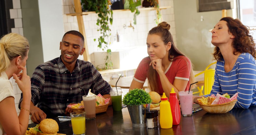Diverse Friends Enjoying Meal and Conversation at Diner