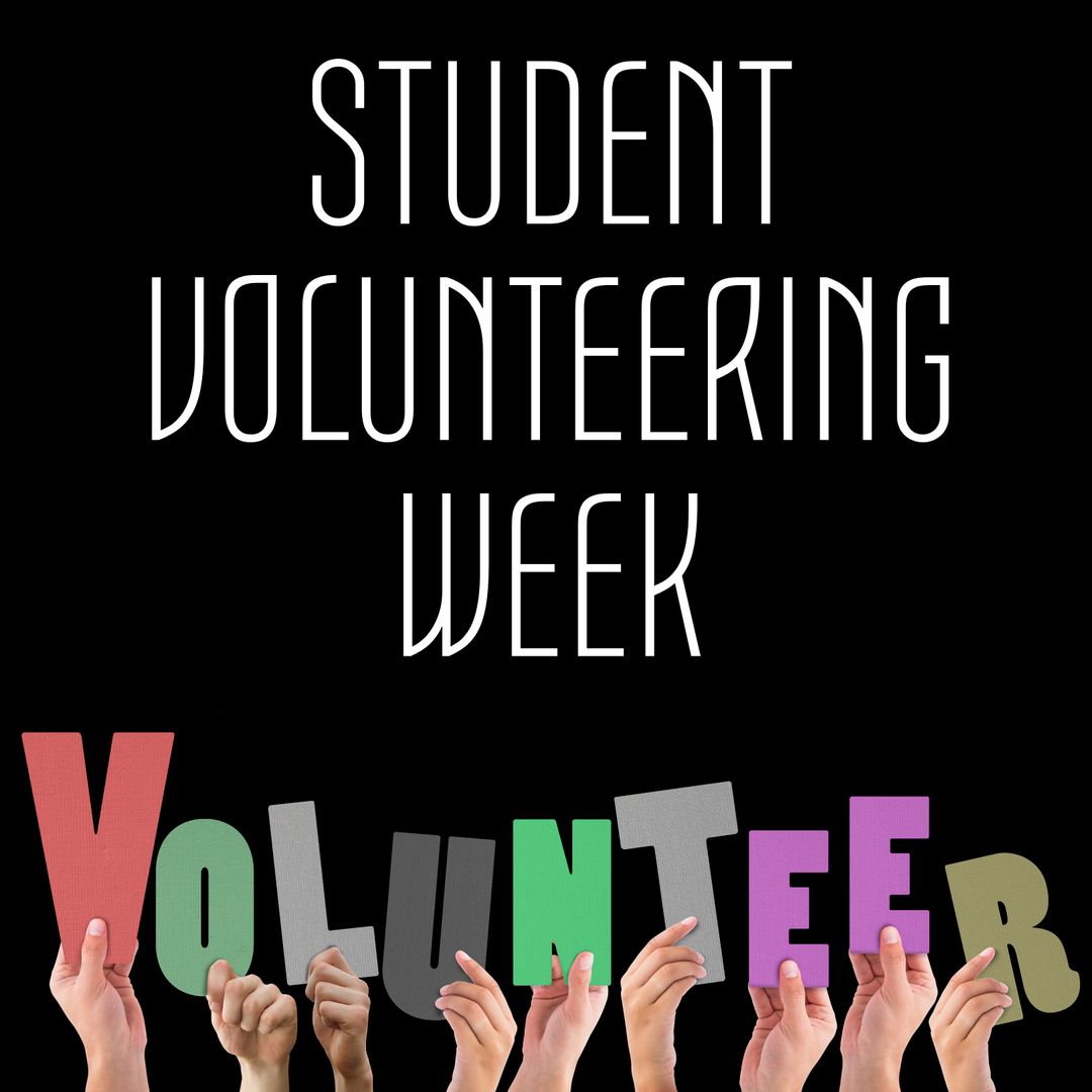 Hands Holding Volunteer Letters Against Black Background