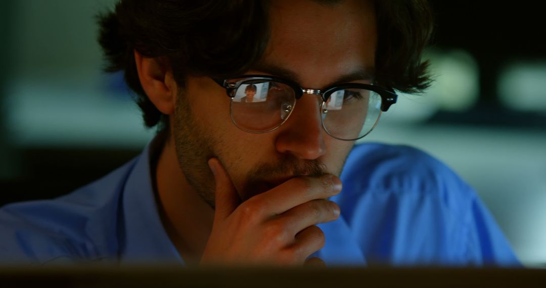 Thoughtful Young Man Working on Computer Late at Night - Free Images, Stock Photos and Pictures on Pikwizard.com