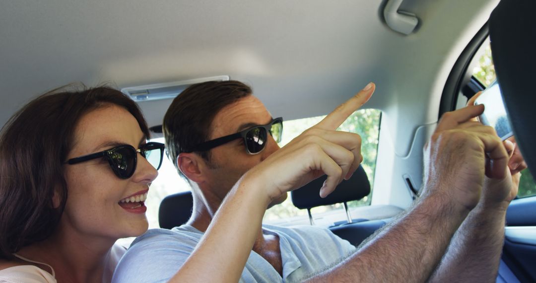 Happy Couple in Car Pointing at Sights During Road Trip - Free Images, Stock Photos and Pictures on Pikwizard.com