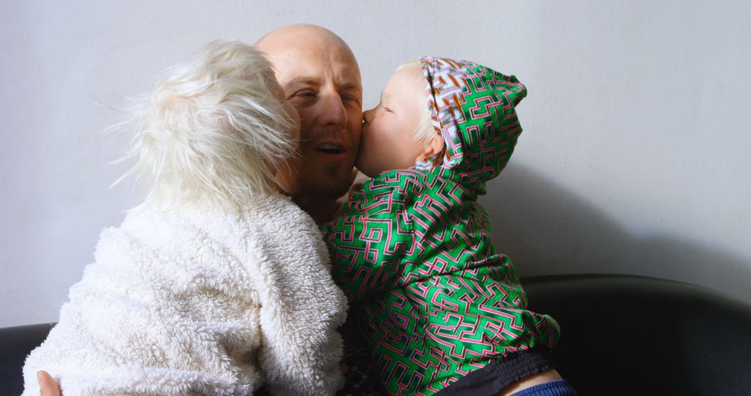 Father Enjoying Affectionate Kisses from Loving Children at Home
