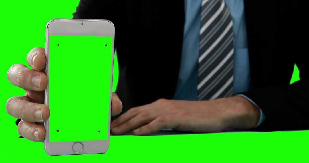 Businessman Holding Smartphone With Green Screen for Mockup - Free Images, Stock Photos and Pictures on Pikwizard.com