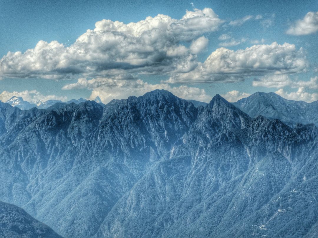 Breathtaking Aerial View of Majestic Mountain Range Under Cloudy Sky - Free Images, Stock Photos and Pictures on Pikwizard.com