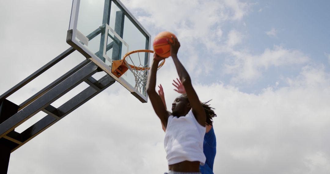 Basketball Player Dunking Ball during Outdoor Game - Free Images, Stock Photos and Pictures on Pikwizard.com