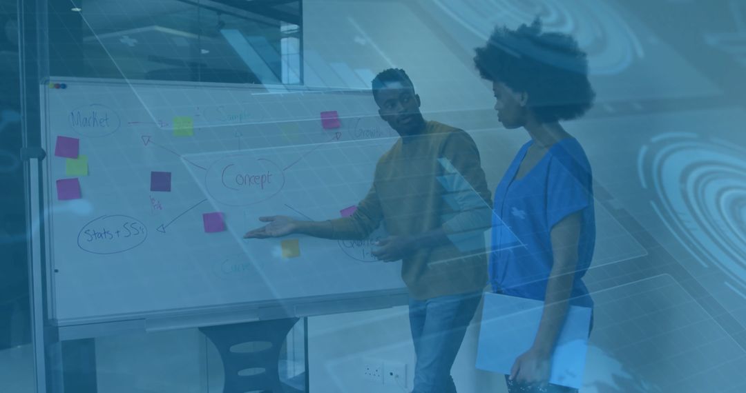 Business Colleagues Discussing Strategies Next to Whiteboard