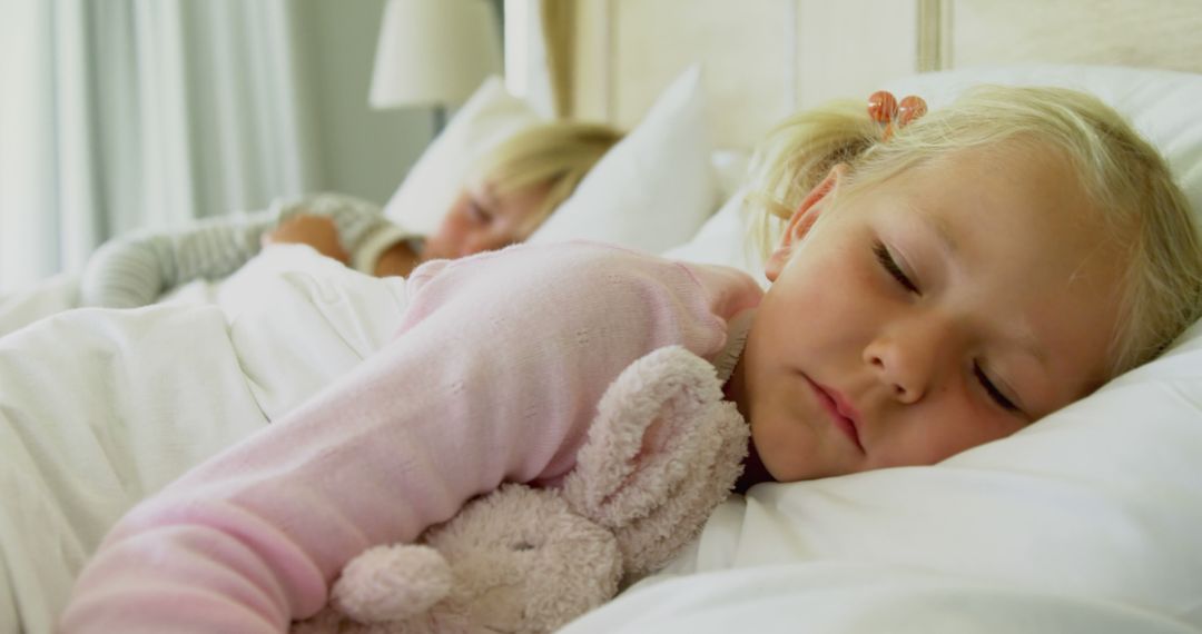 Young Girl Sleeping Peacefully Cuddling Stuffed Animal in Bed - Free Images, Stock Photos and Pictures on Pikwizard.com