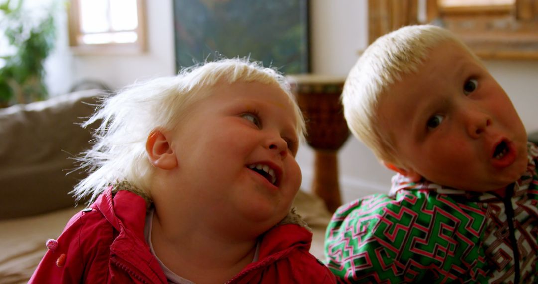 Caucasian Siblings Relaxing and Smiling at Home