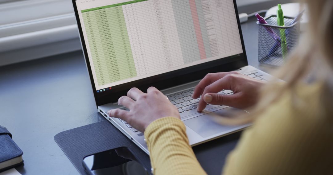 Businesswoman Analyzing Data Spreadsheets on Laptop at Home Office
