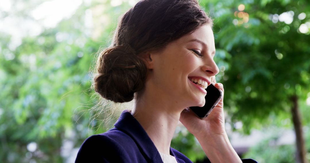 Smiling Businesswoman Talking on Smartphone Outdoors - Free Images, Stock Photos and Pictures on Pikwizard.com