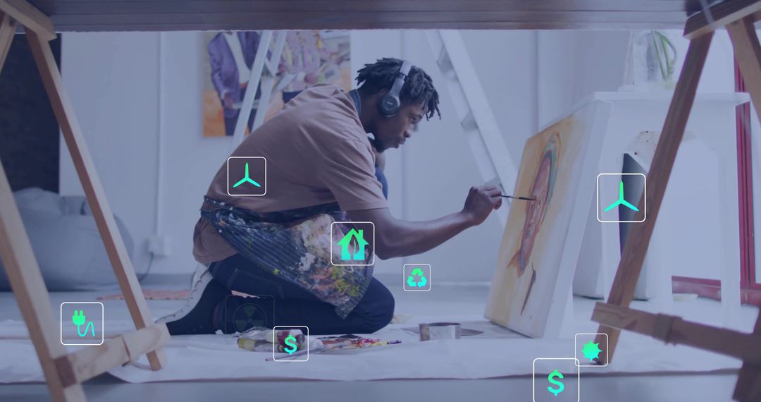 Kneeling Artist Painting Canvas with Eco-Friendly Icons in Studio