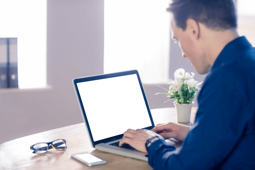 Businessman Working on Transparent Screen Laptop at Office Desk