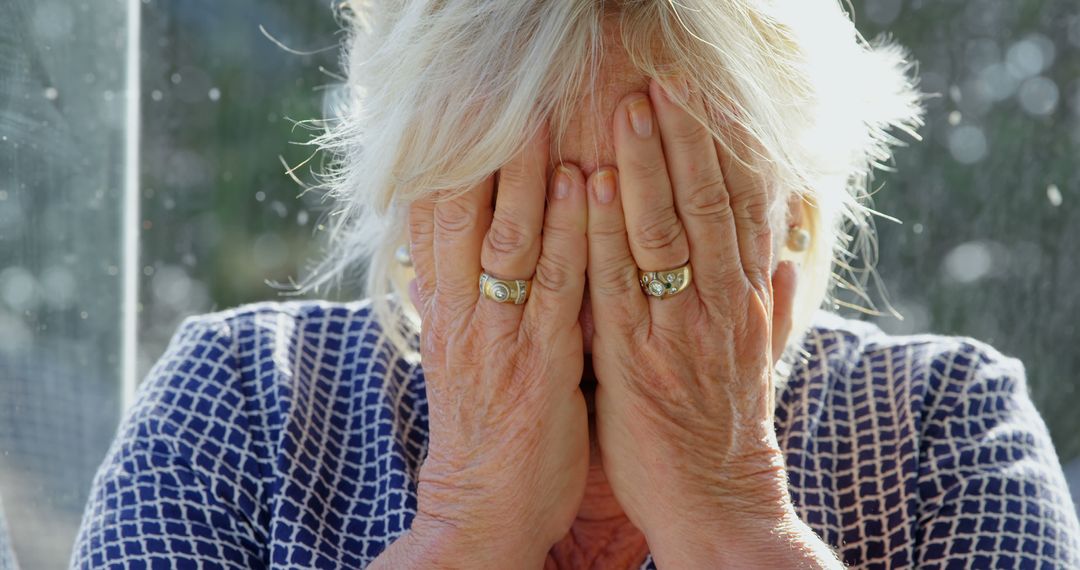 Elderly Woman Covering Face with Hands in Emotional Moment - Free Images, Stock Photos and Pictures on Pikwizard.com