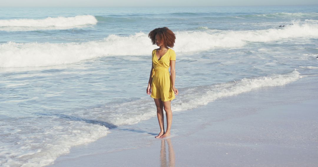 Young Woman in Yellow Dress Walking on Beach - Free Images, Stock Photos and Pictures on Pikwizard.com