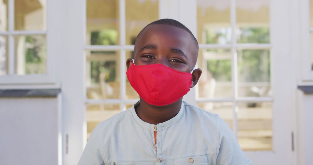 Happy African American Child Wearing Red Face Mask Outdoors - Free Images, Stock Photos and Pictures on Pikwizard.com