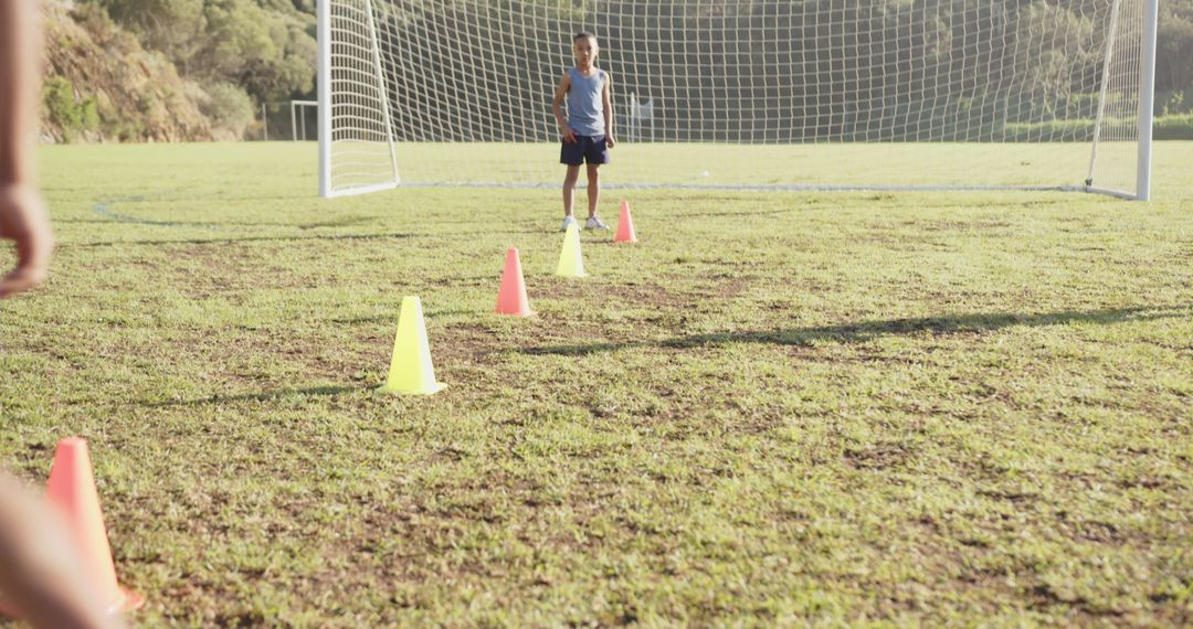 Children Training with Cones on Soccer Field