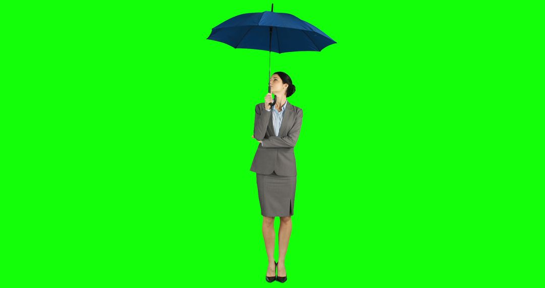 Businesswoman Standing with Umbrella Isolated on Green Background - Free Images, Stock Photos and Pictures on Pikwizard.com