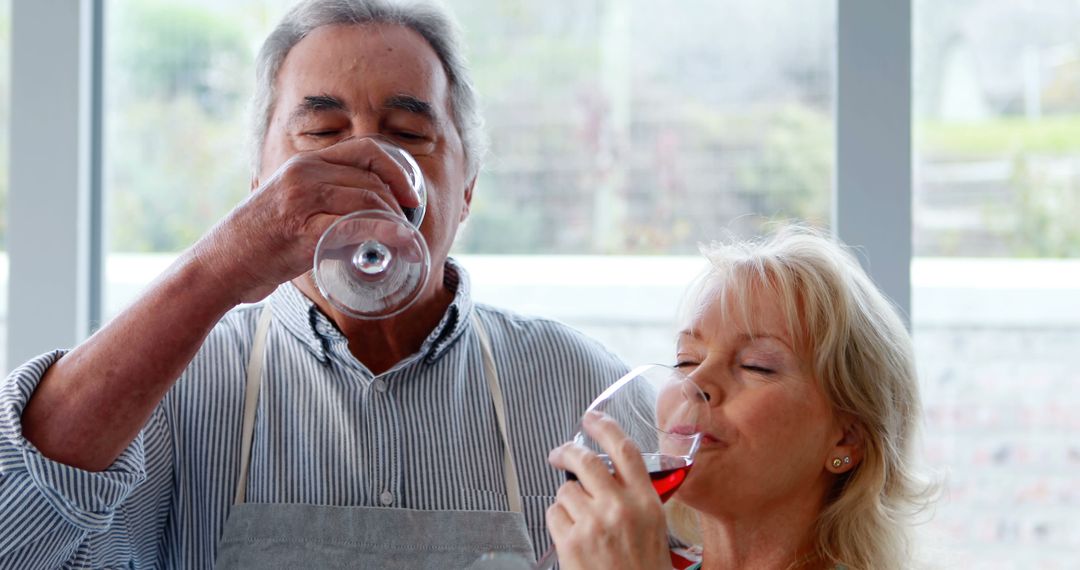A senior Caucasian couple enjoys a glass of wine together in a bright, airy room, with copy space - Free Images, Stock Photos and Pictures on Pikwizard.com