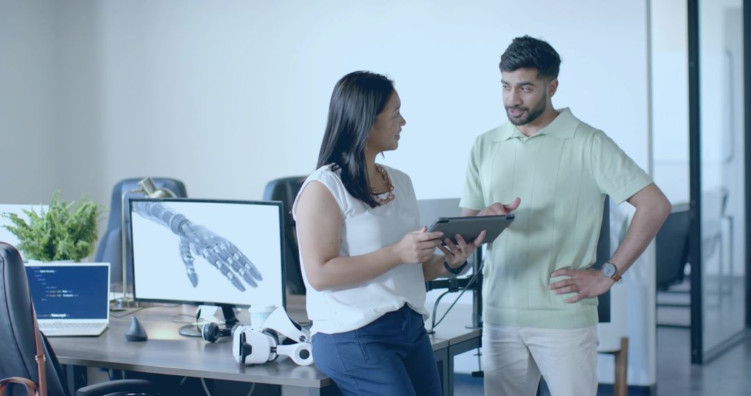 Colleagues Discussing Tech Design in Modern Office Environment