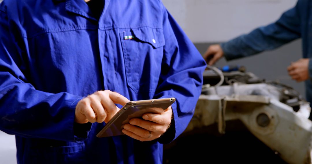 Automotive Technician Using Tablet for Diagnostics in Workshop - Free Images, Stock Photos and Pictures on Pikwizard.com