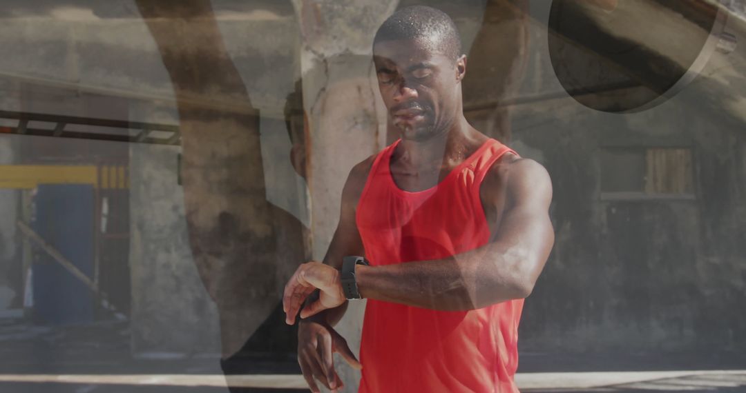 Runner in Red Tank Top Checking Smartwatch in Urban Setting