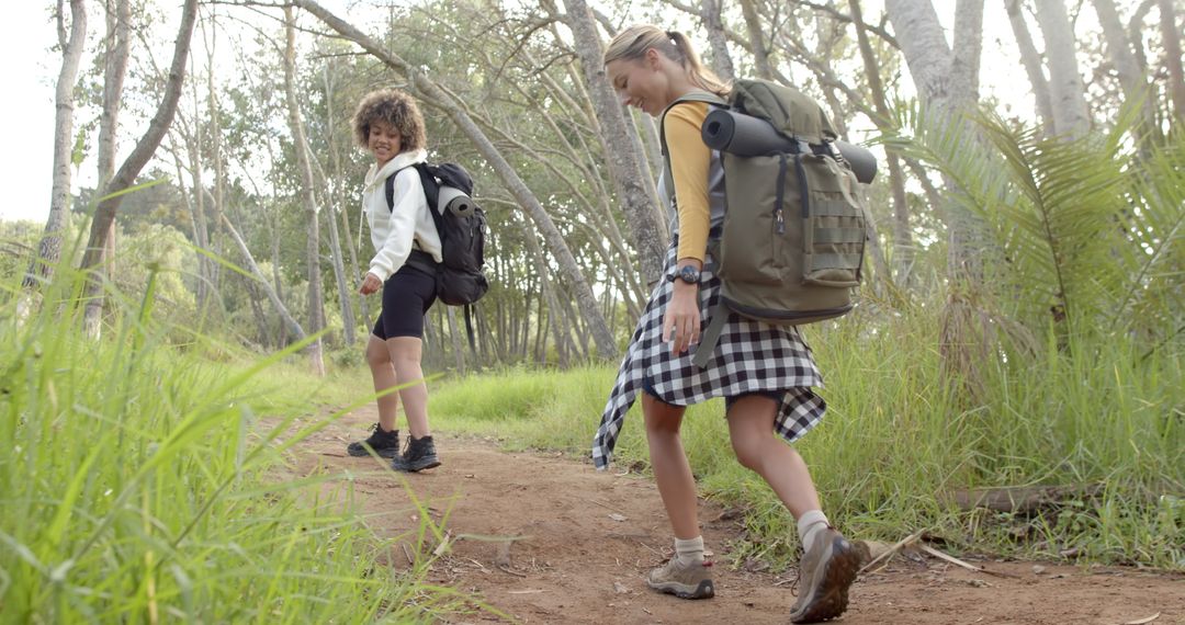 Children Smiling While Hiking Through Lush Green Forest Path