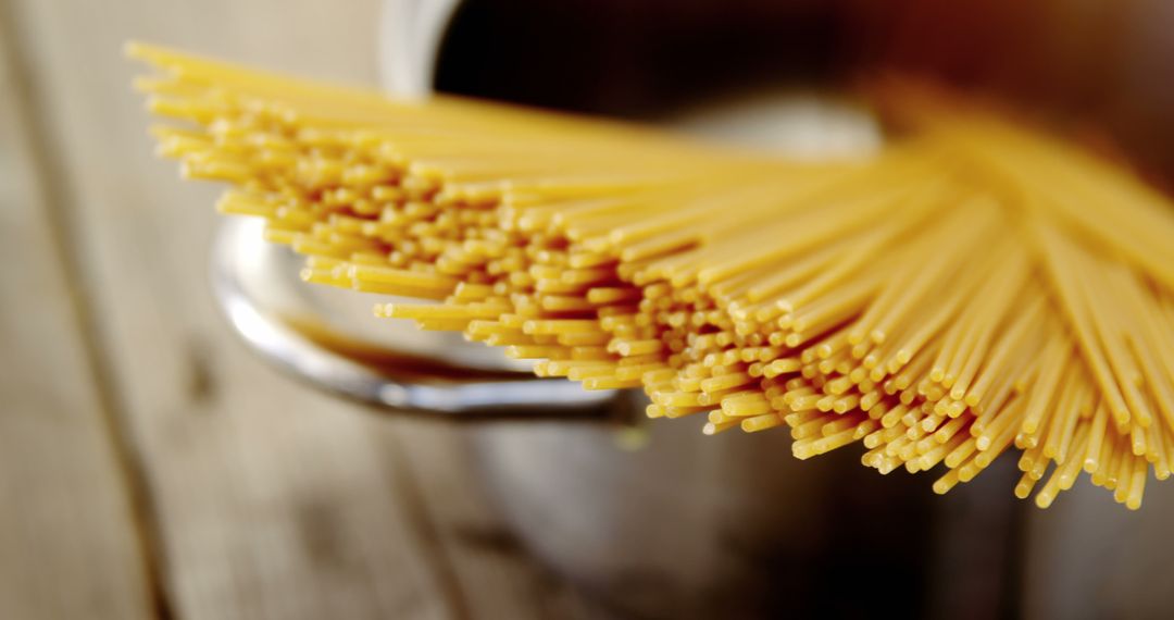 Uncooked Spaghetti Noodles on Wooden Surface in Pot - Free Images, Stock Photos and Pictures on Pikwizard.com