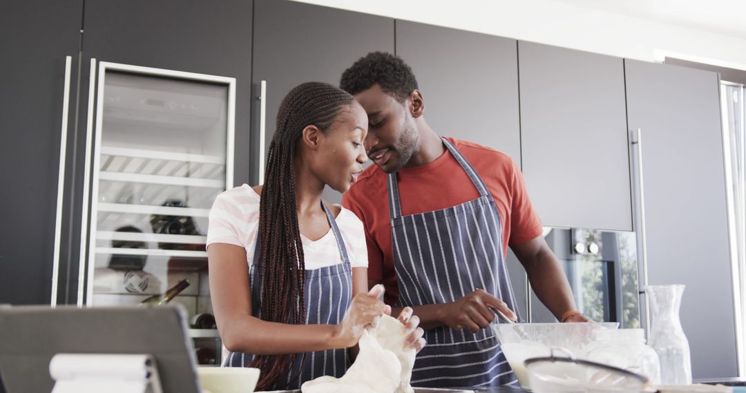 Couple Preparing Bread Dough in Kitchen with Tablet