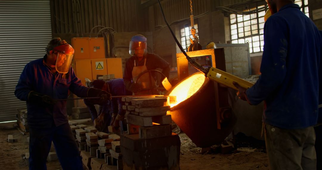 Industrial Workers Pouring Molten Metal in Foundry Workshop - Free Images, Stock Photos and Pictures on Pikwizard.com