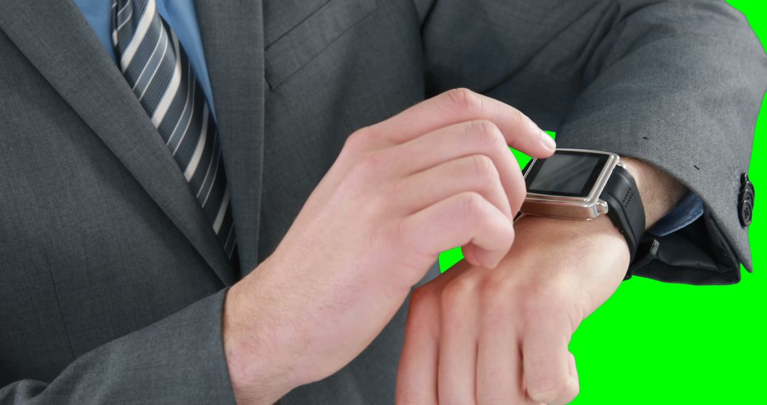 Businessperson Adjusting Modern Smartwatch with Green Screen Background - Free Images, Stock Photos and Pictures on Pikwizard.com