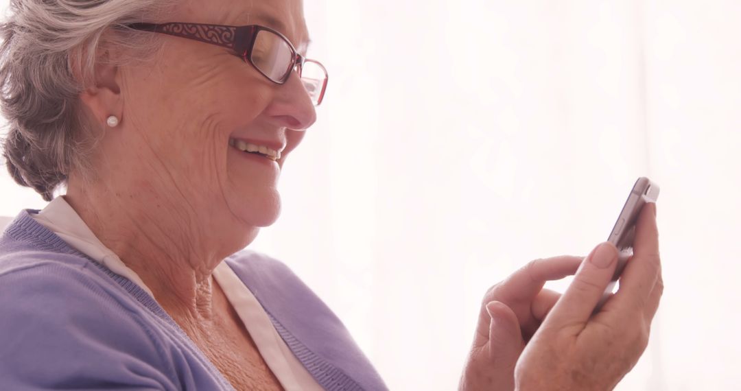 Happy Senior Woman Using Smartphone - Free Images, Stock Photos and Pictures on Pikwizard.com