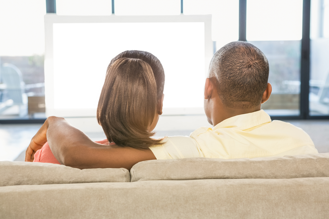 Casual Couple Relaxing on Sofa Watching Transparent TV Screen at Home - Download Free Stock Images Pikwizard.com