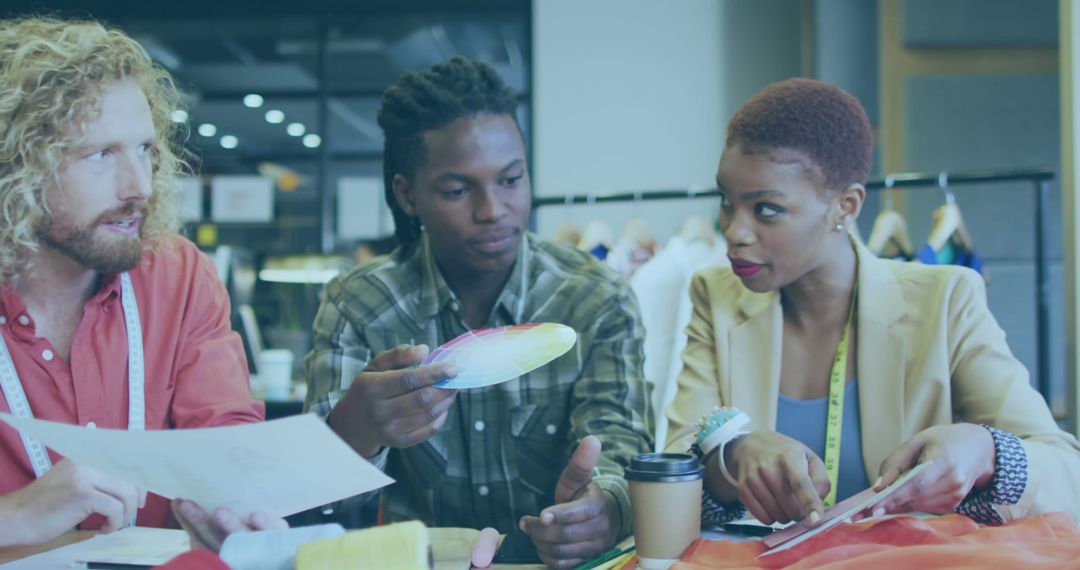 Creative Team Collaborating in Modern Workspace with Color Samples