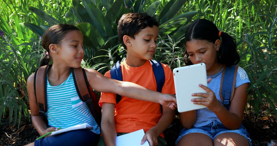 Diverse Kids Using Tablet and Studying Outdoors Together - Free Images, Stock Photos and Pictures on Pikwizard.com