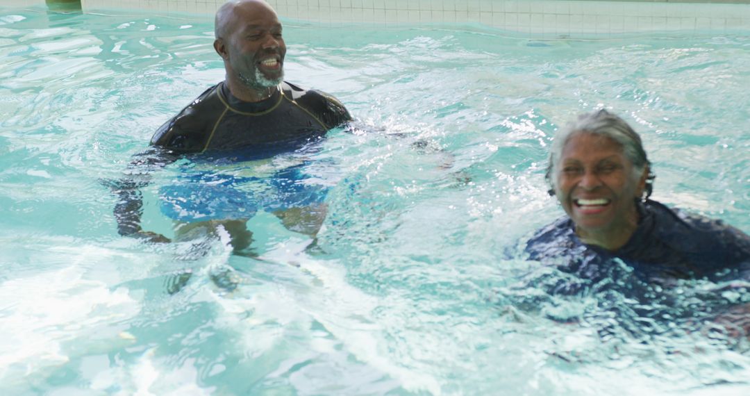 Image of happy senior african american couple swimming in pool - Free Images, Stock Photos and Pictures on Pikwizard.com