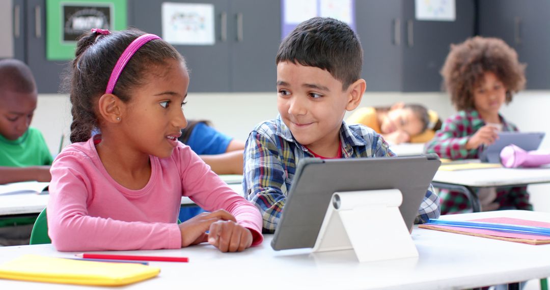 Students Collaborating with Tablet for Learning in Classroom