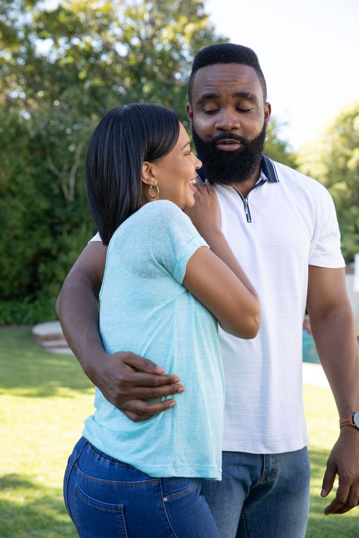 Affectionate Couple Relaxing in Sunlit Garden