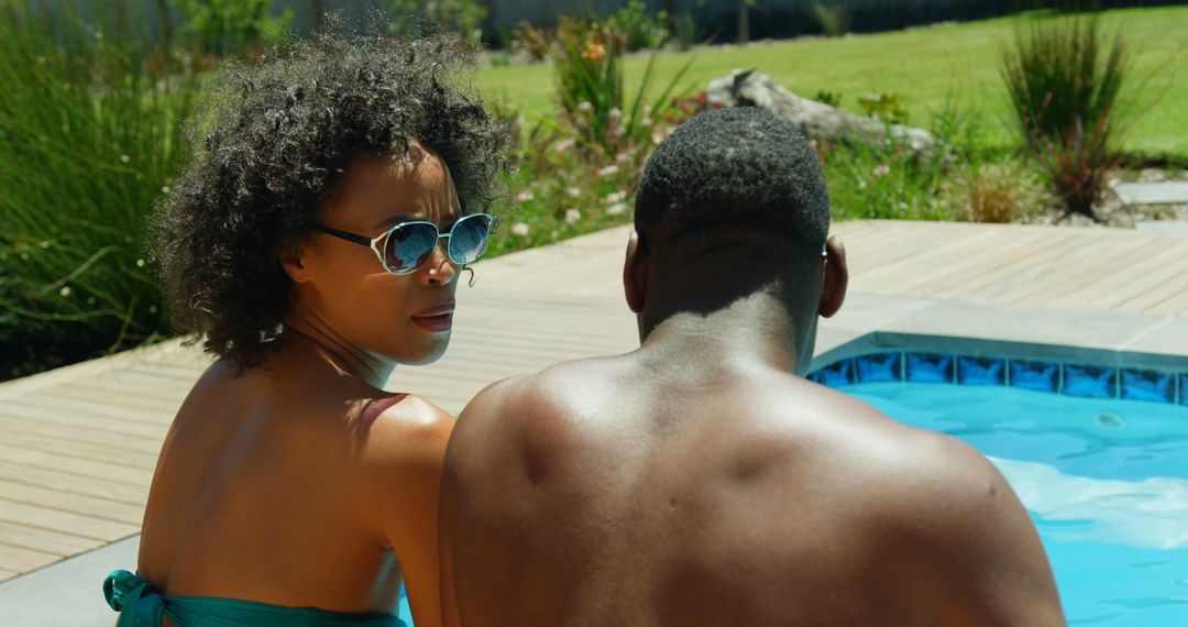 Couple Relaxing by Poolside on Sunny Day - Free Images, Stock Photos and Pictures on Pikwizard.com