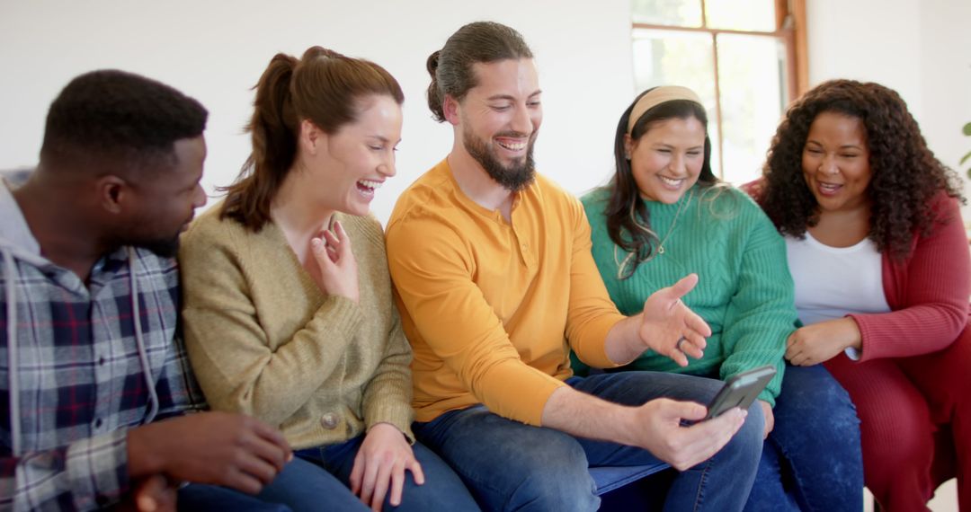 Group of Diverse Friends Smiling and Looking at Smartphone Together - Free Images, Stock Photos and Pictures on Pikwizard.com