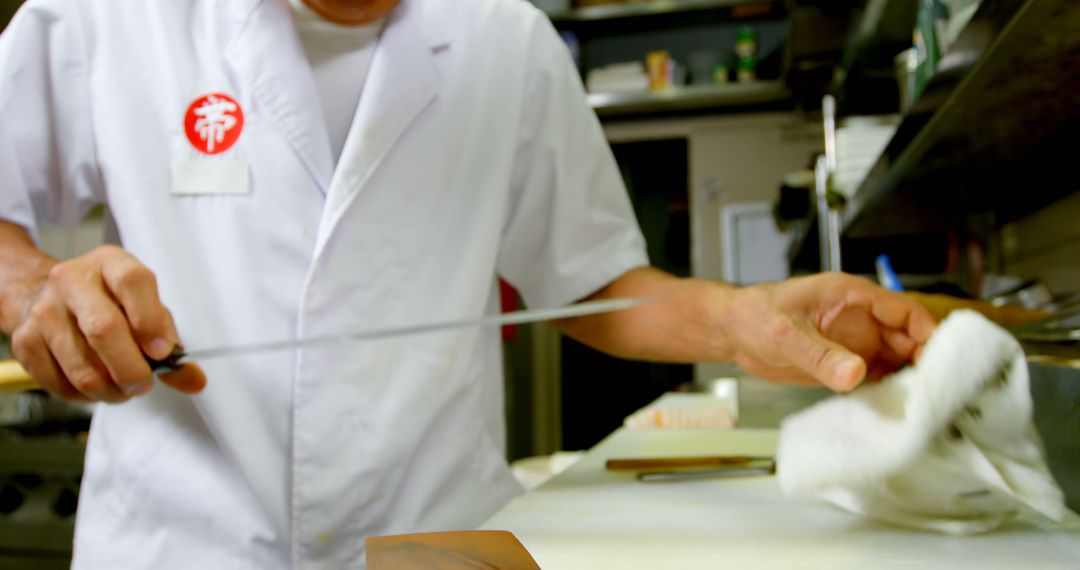 Senior Chef Demonstrates Skillful Knife Technique in Professional Kitchen - Free Images, Stock Photos and Pictures on Pikwizard.com