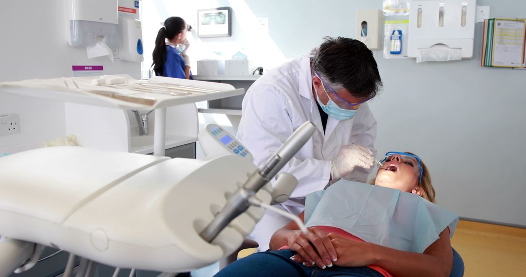 Dentist Treating Female Patient in Modern Clinic - Free Images, Stock Photos and Pictures on Pikwizard.com